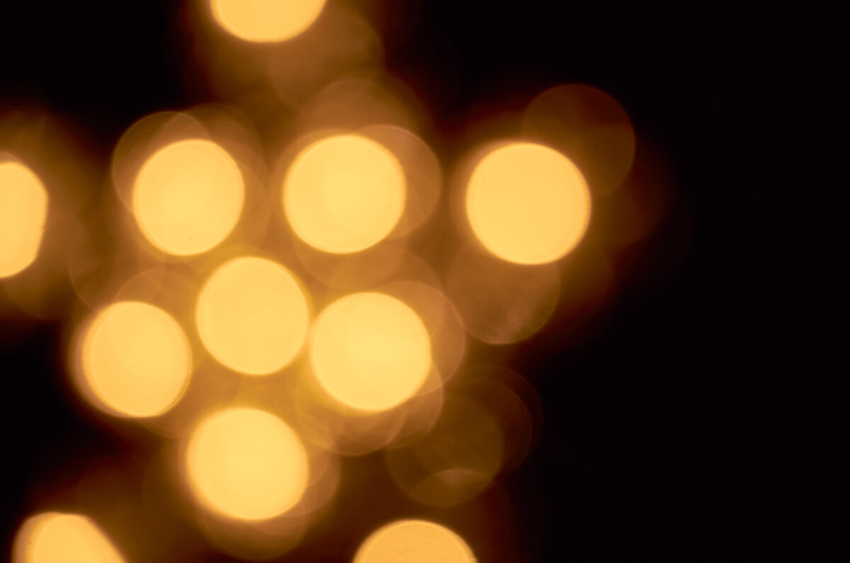 Warm, defocused points of light against black