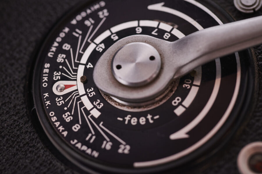 Close-up of a vintage camera's focus dial