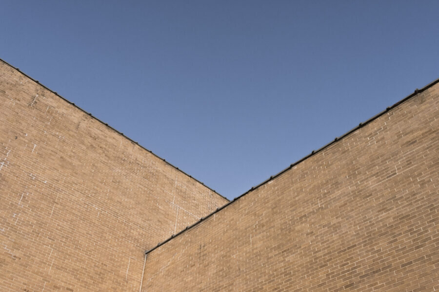 The sharp corner of a building against a plain sky