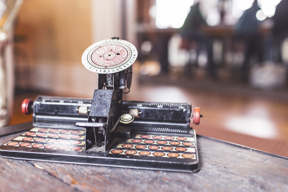 A vintage typewriter on a wooden desk